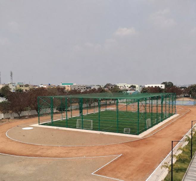 Concept image of a netted football turf ringed by a running track